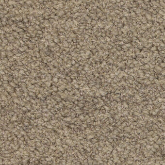 Beige looped pile fabric texture with a matte finish, displaying a nubby surface and subtle mottled variations, plus a printed label.